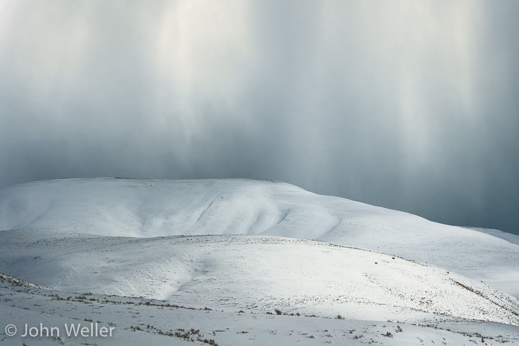 Clouds of ice and snow evaporate over ridges in Lamar Valley.