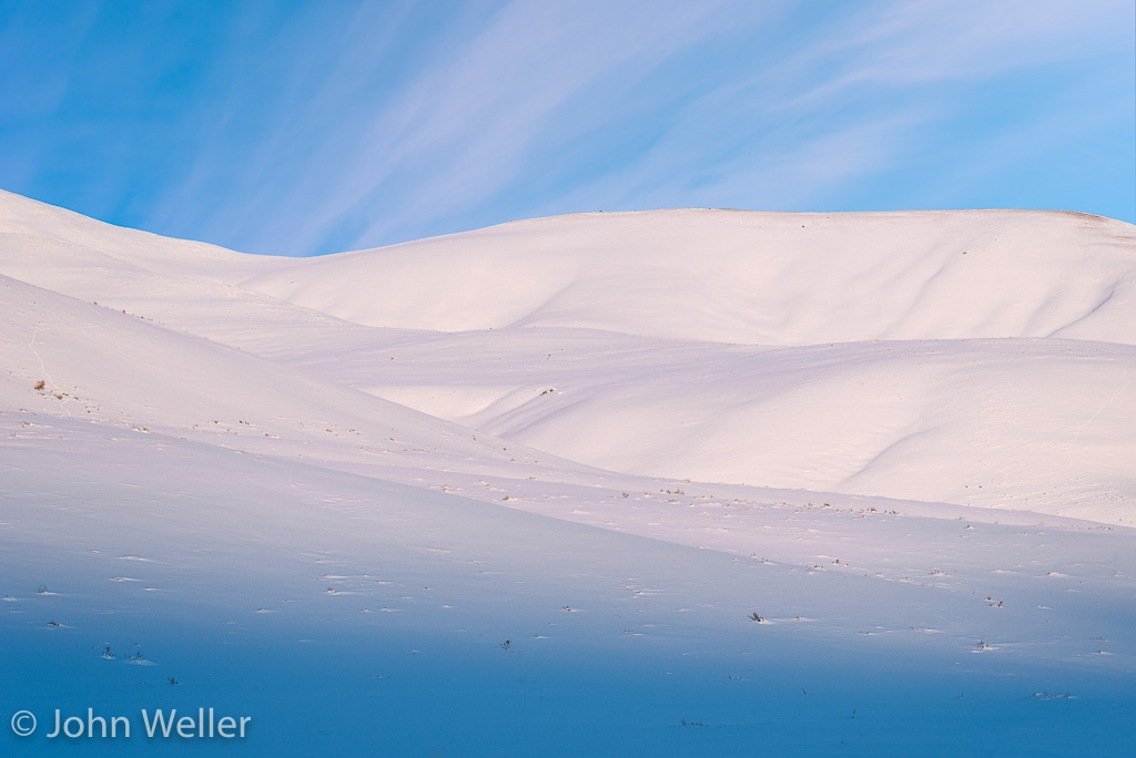 Sunset in Lamar Valley colors the snow covered mountains in pastels.