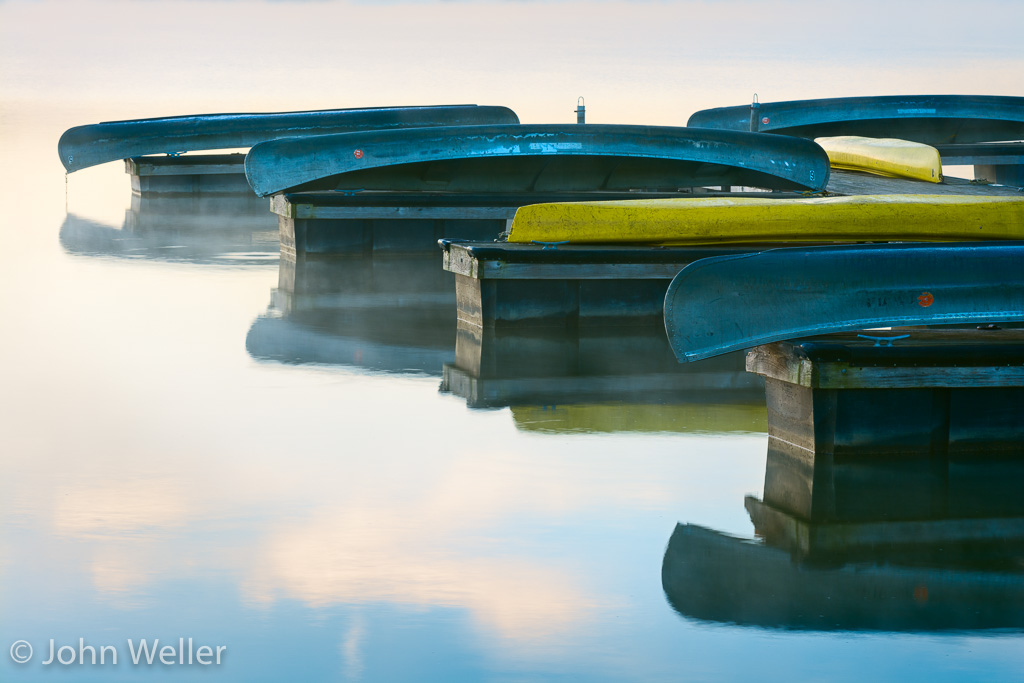 Canoes on a dock at Acton Lake on a misty morning.