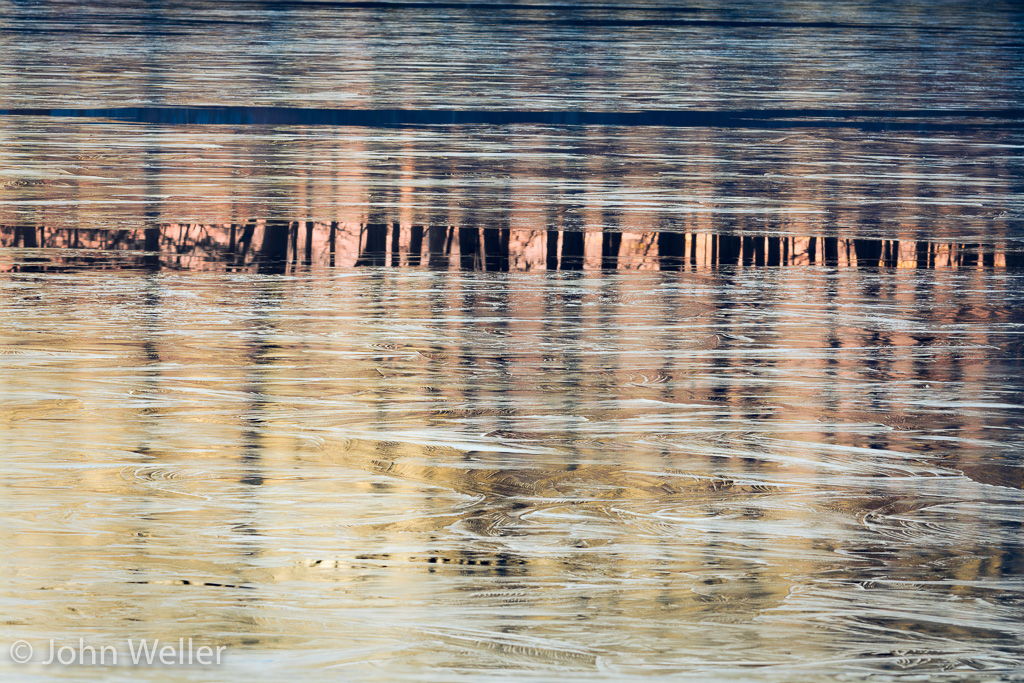 Ice reflects the colors of dawn on Miami Whitewater Forest Lake.